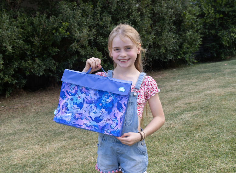child carrying a library bag